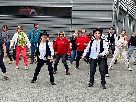 Eine Gruppe Tänzer ist zum Linedance aufgestellt