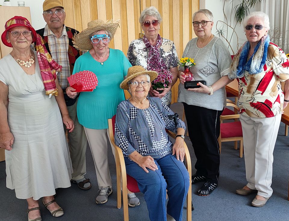 Seniorinnen verkleidet in Sommermode stehen in der Begegnungsstätte Langenweddingen